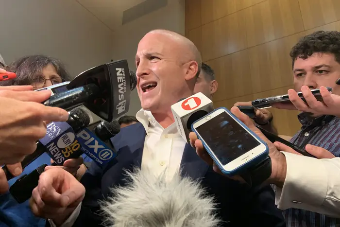 Rep. Max Rose speaks to reporters after a town hall meeting on Wednesday night.